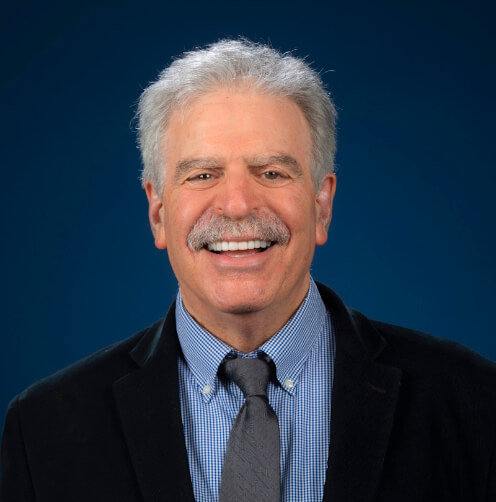 Dan Cooper, MD, headshot against a dark blue backdrop