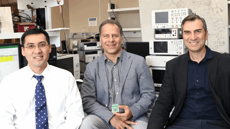 Three professors in a lab space.