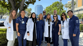 A group of UCI Health co-workers celebrating Donate Life Month outside the UCI Health - Orange hospital..