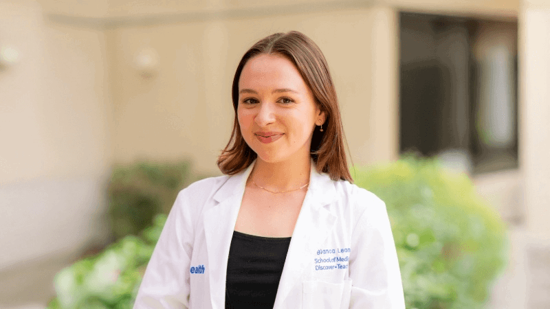 MD/PhD student Bianca Leonard in her white coat.