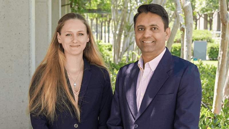 Casey Hudson and Munjal M. Acharya, PhD, outside.