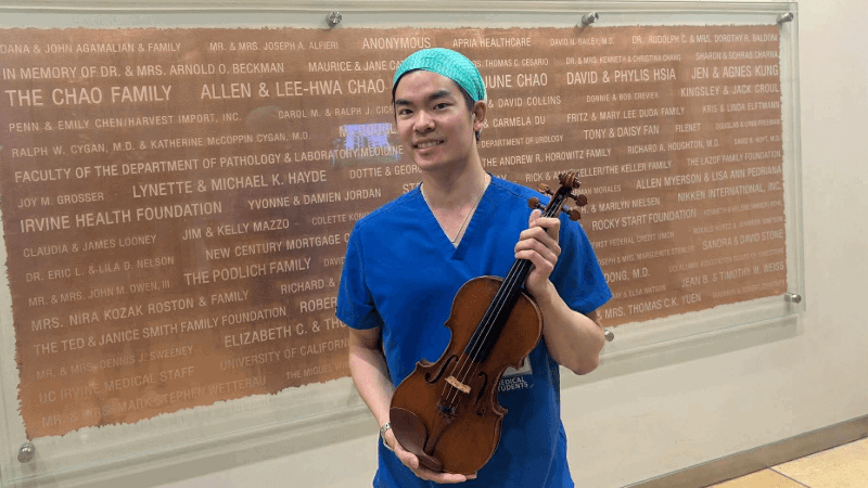 Frank Lee holding a violin 